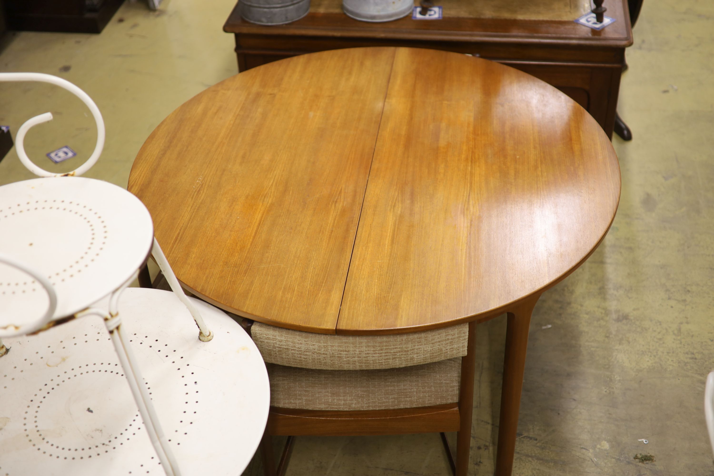 A mid century design Macintosh circular teak extending dining table and four chairs, model 9533, table width 170cm extended depth 122cm height 74cm